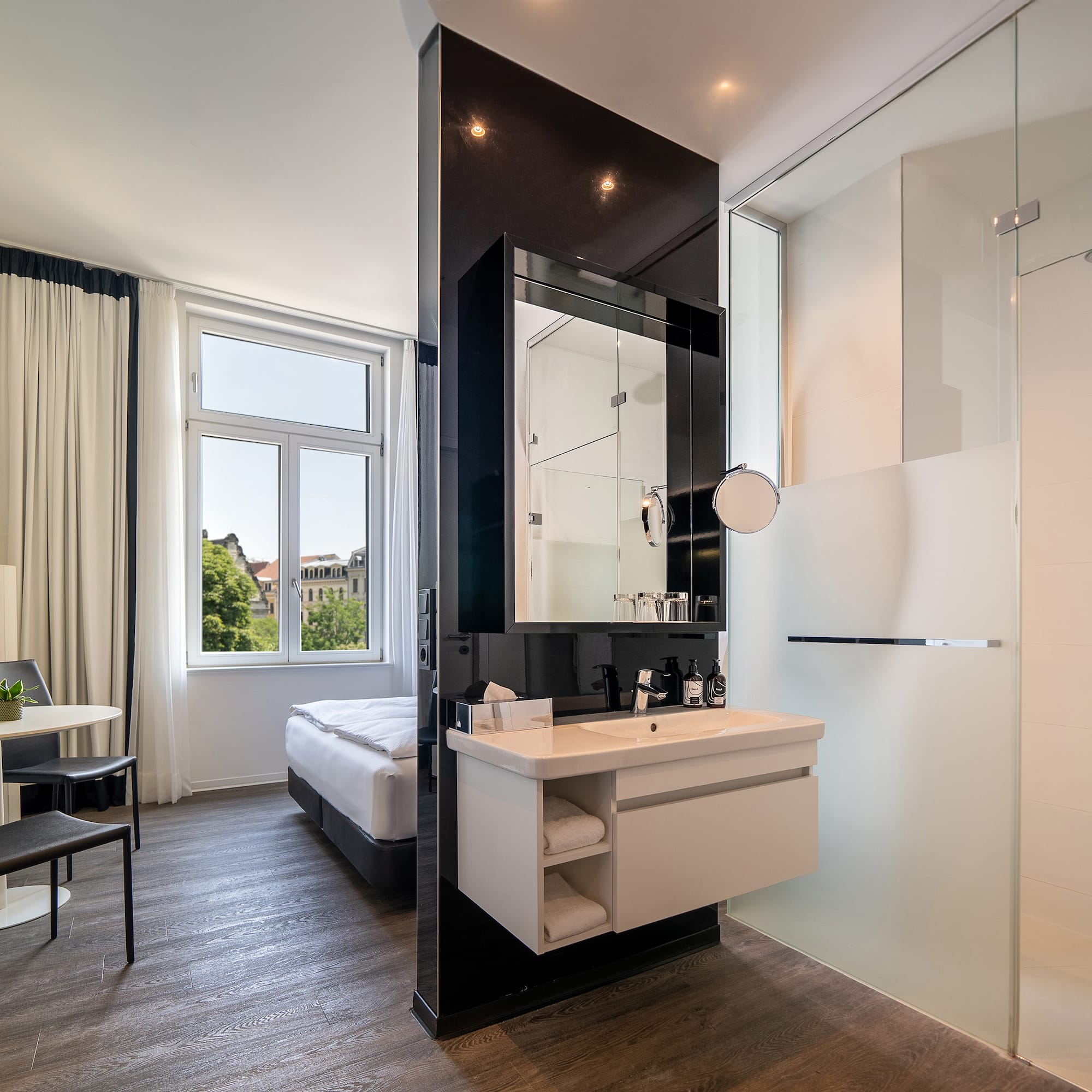 a bathroom with a shower and a bed