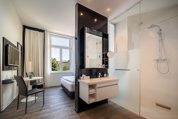 a bathroom with a shower and a bed