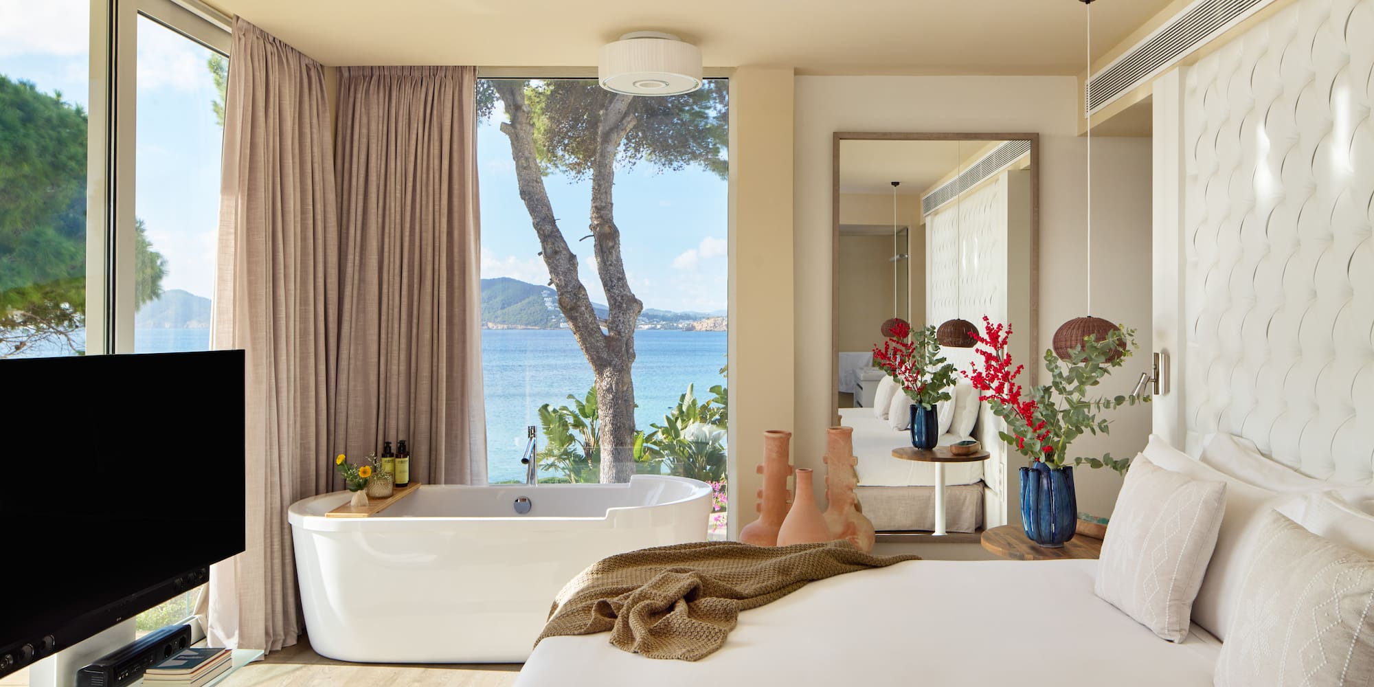 a room with a bathtub and a large window