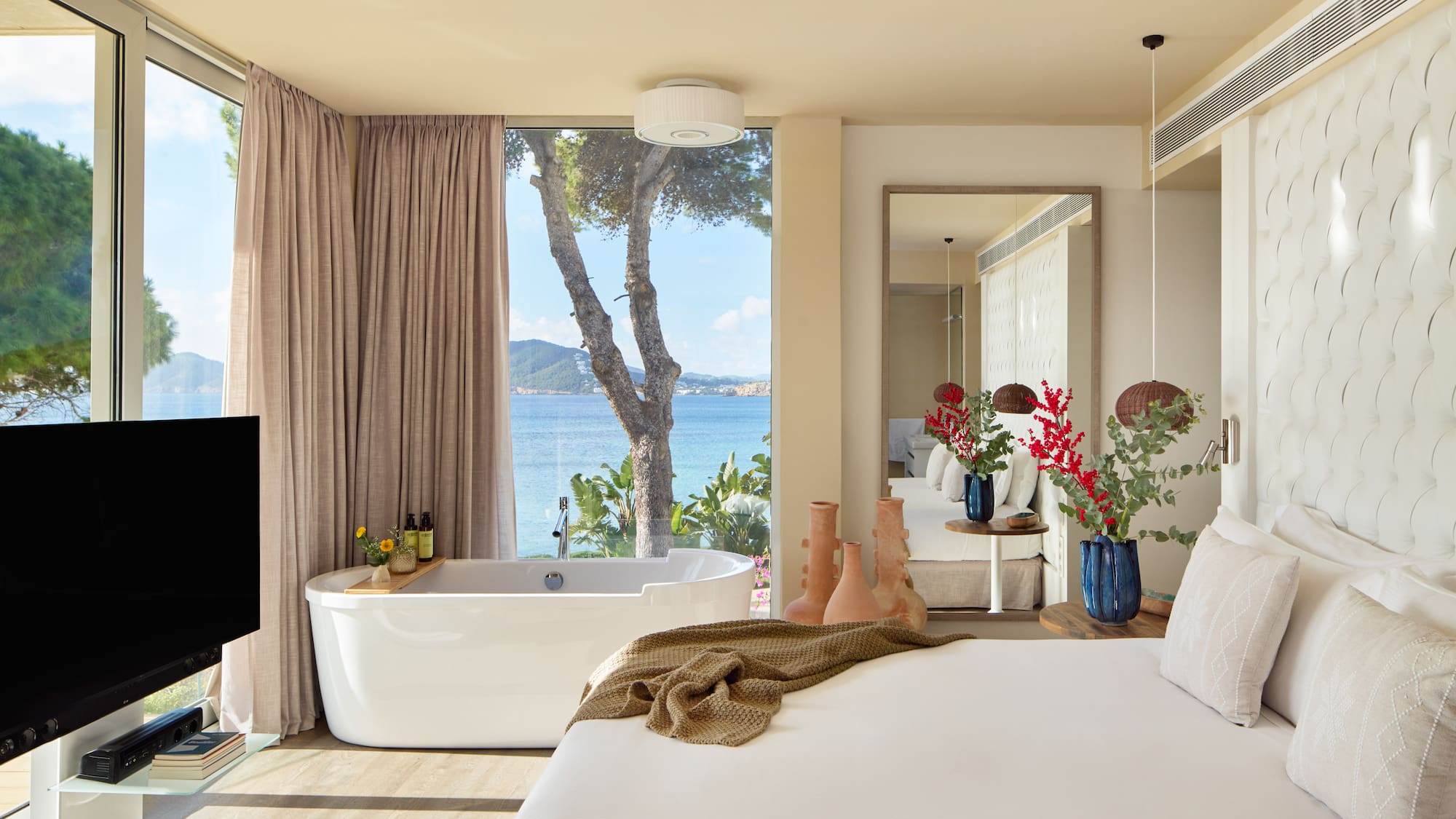 a room with a bathtub and a large window