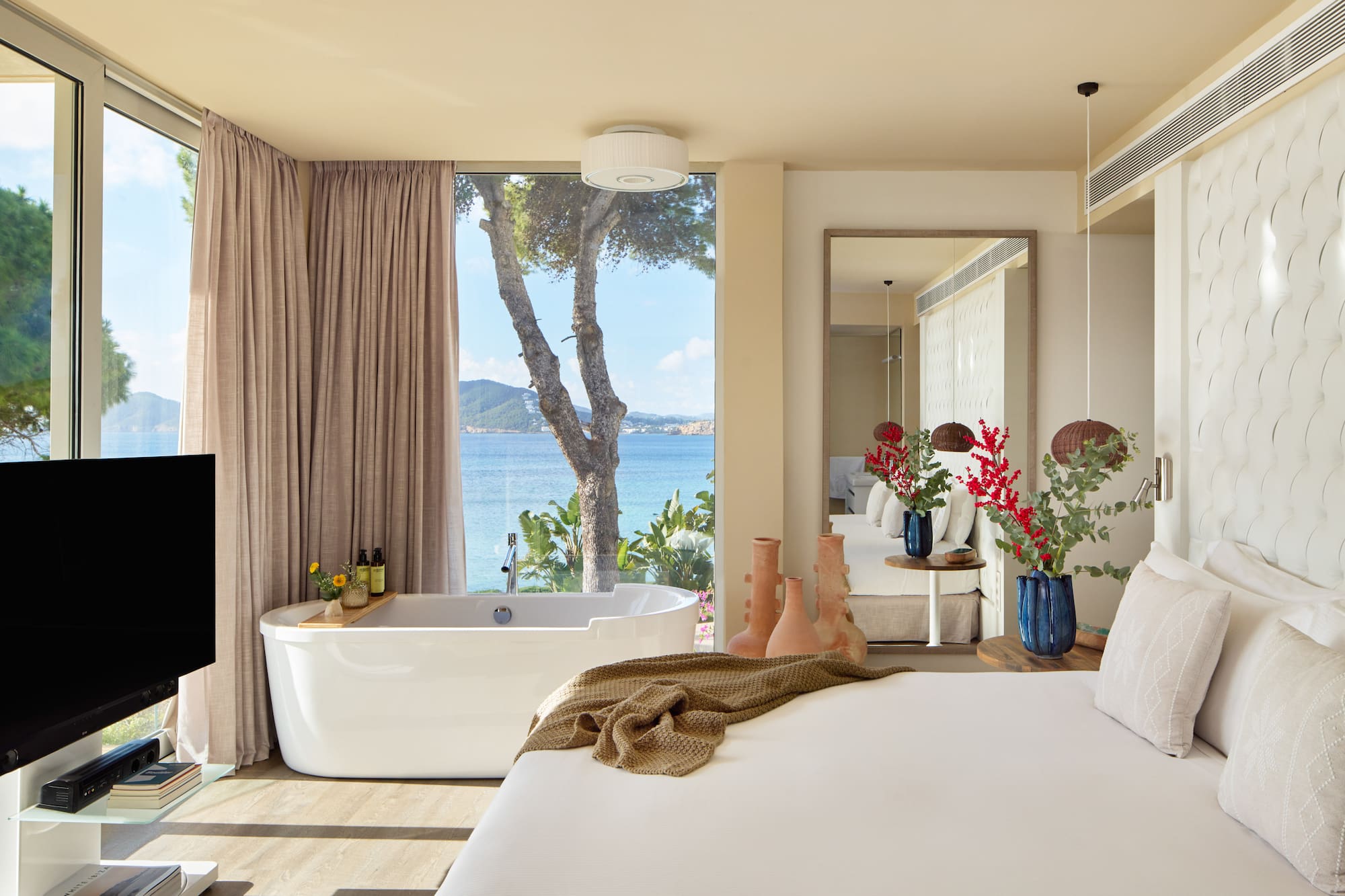 a room with a bathtub and a large window