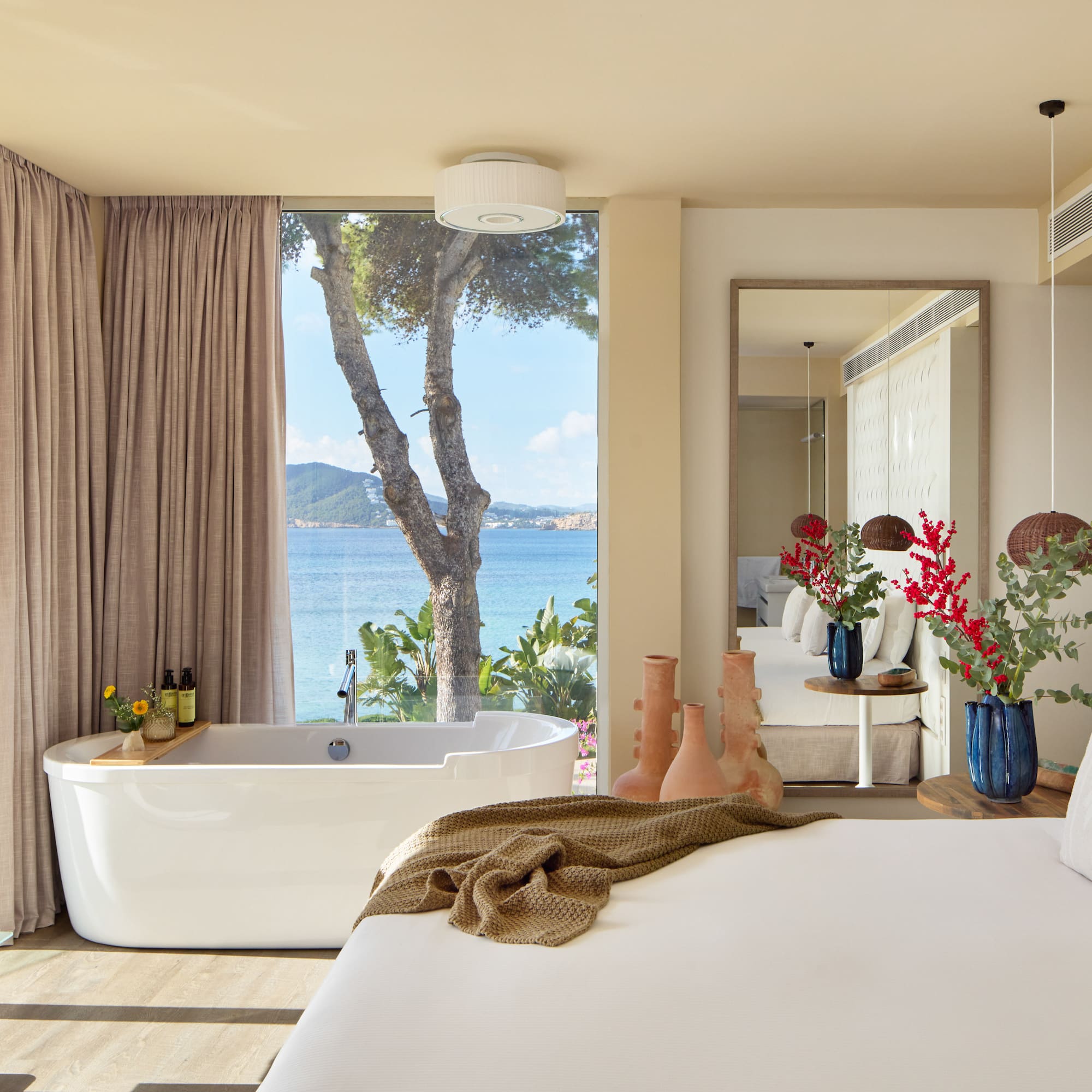 a room with a bathtub and a large window