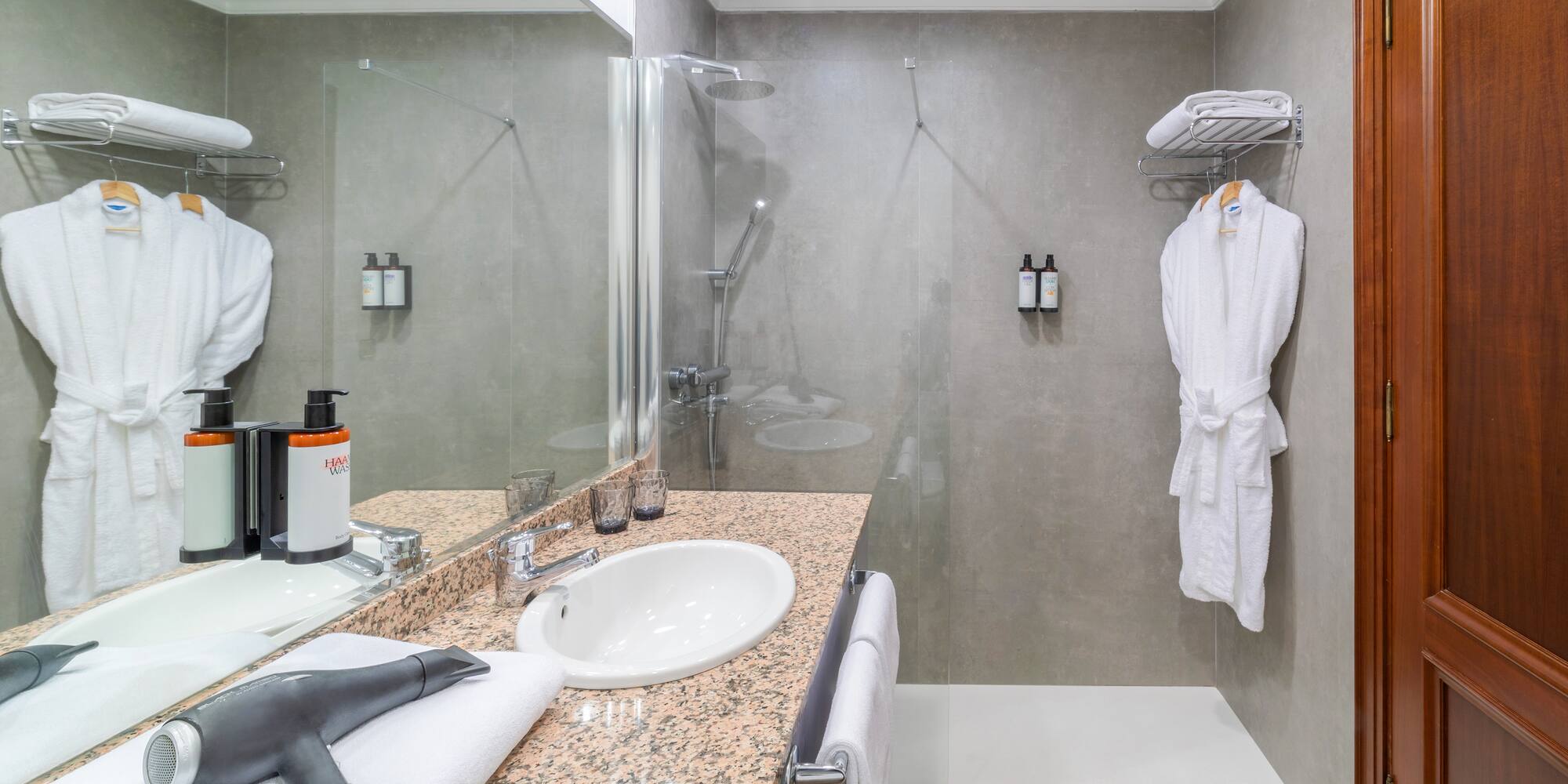a bathroom with a shower and a sink