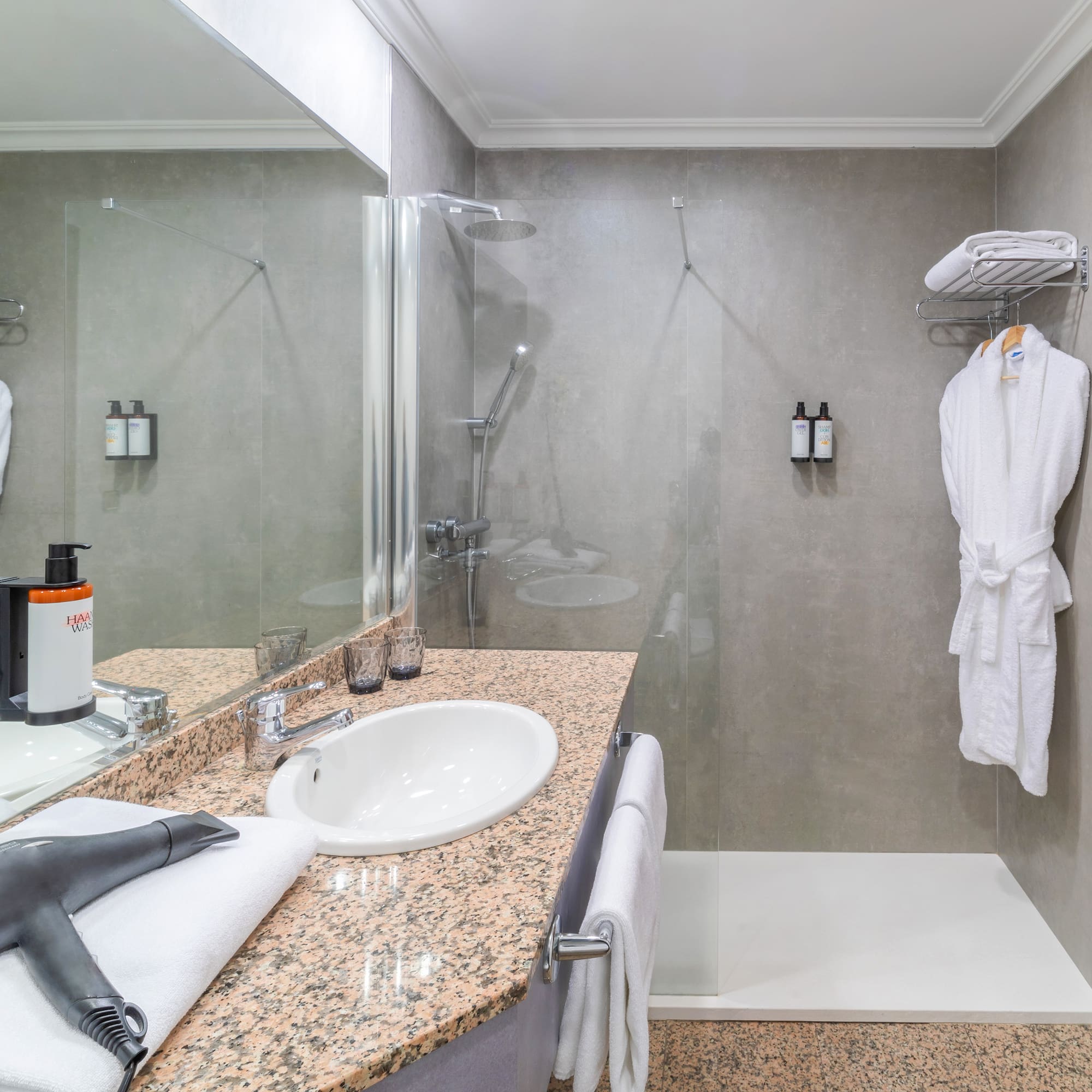 a bathroom with a shower and a sink