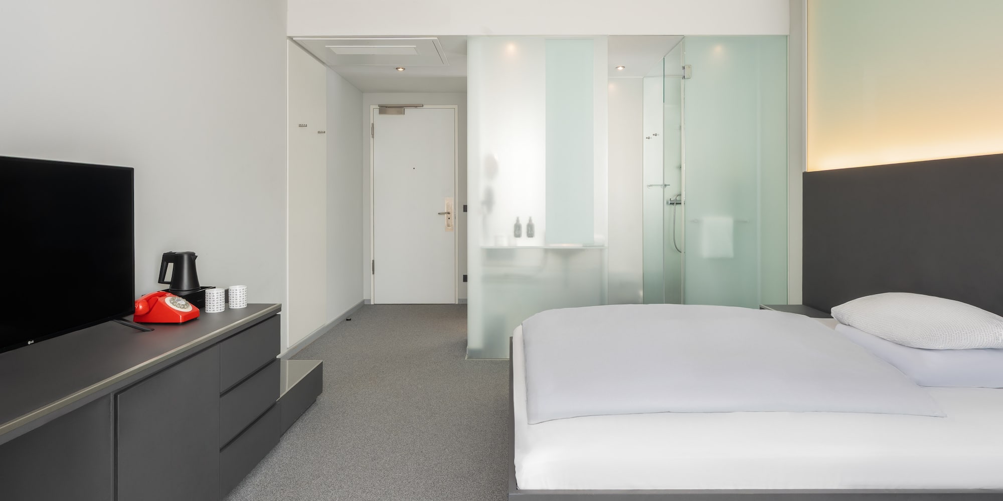 a bedroom with a bed and a shower