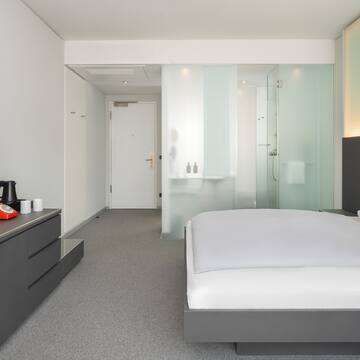 a bedroom with a bed and a shower