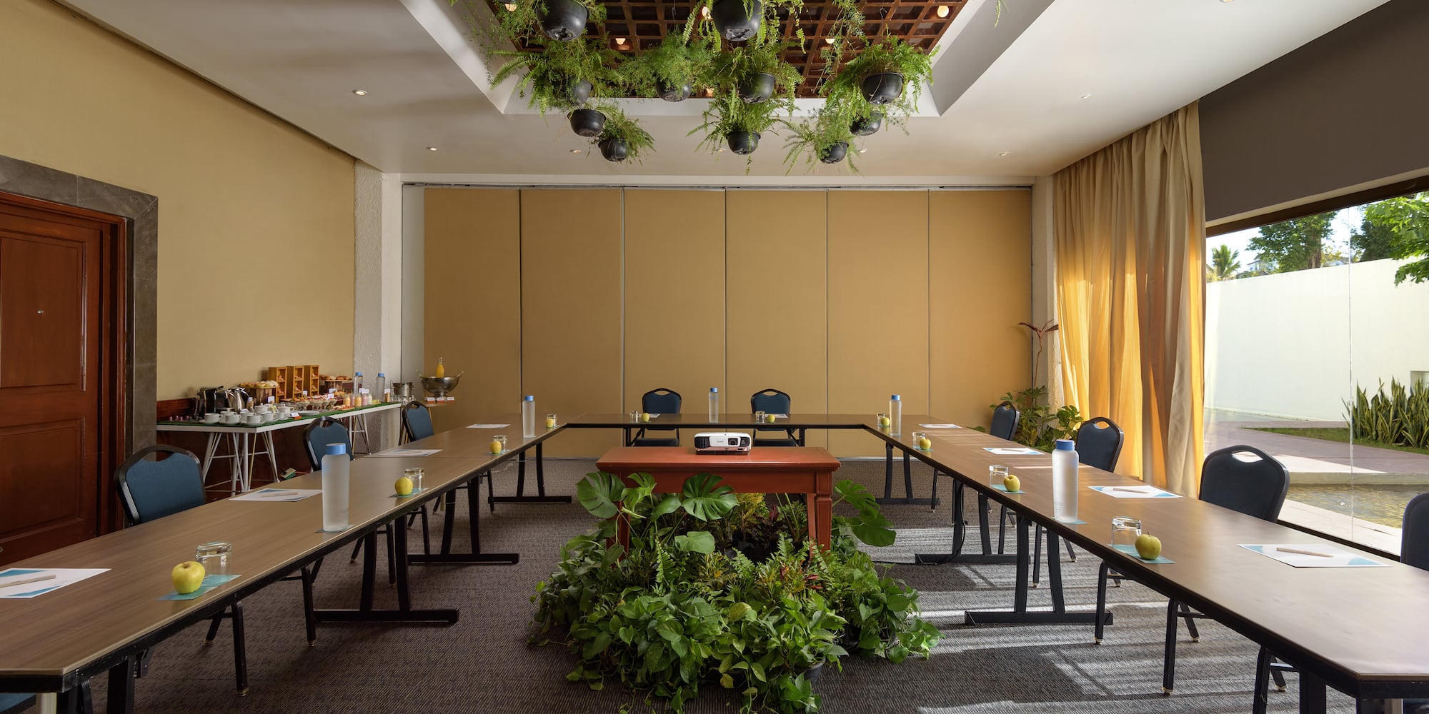a room with long tables and chairs