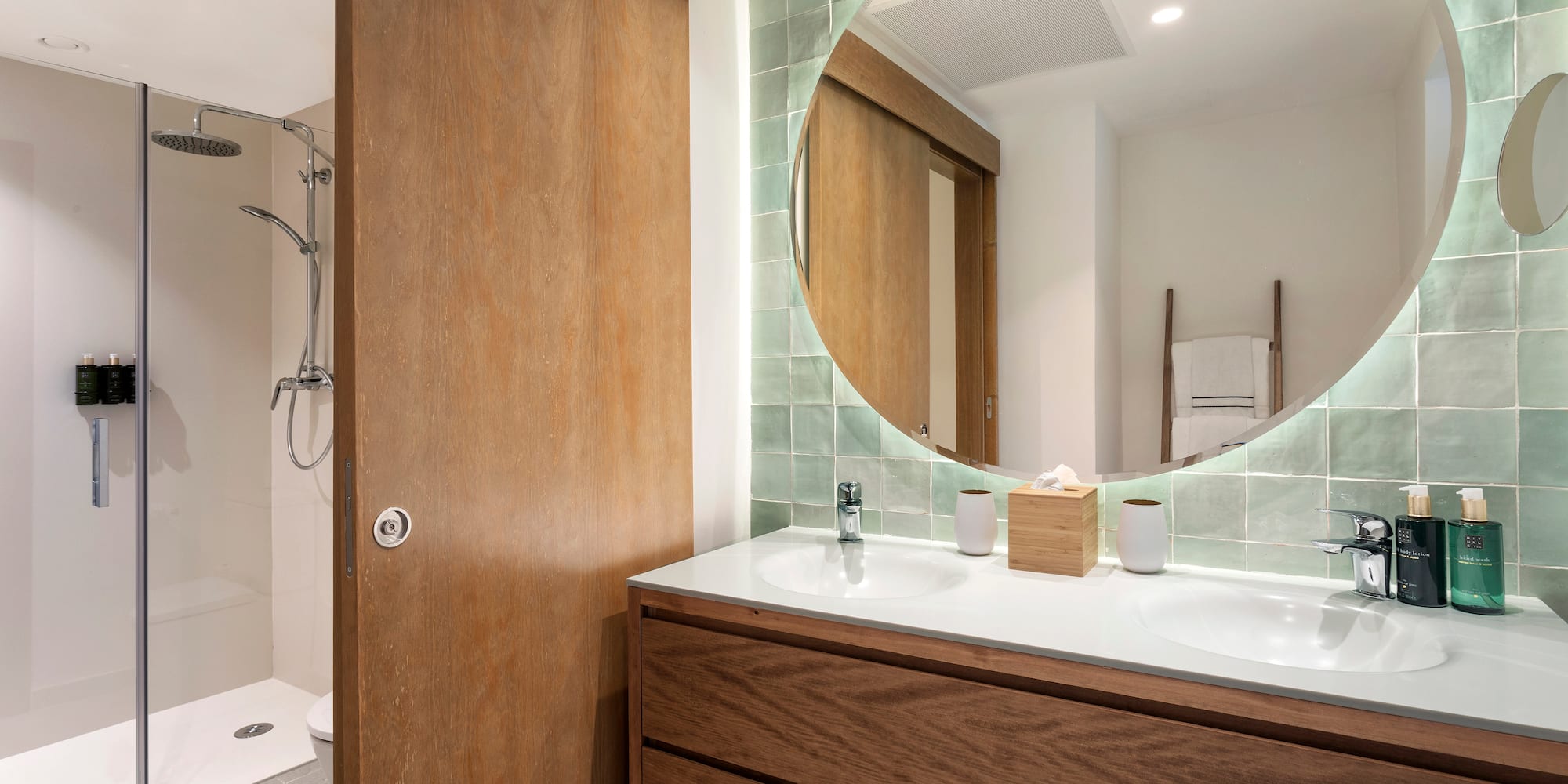 a bathroom with a round mirror