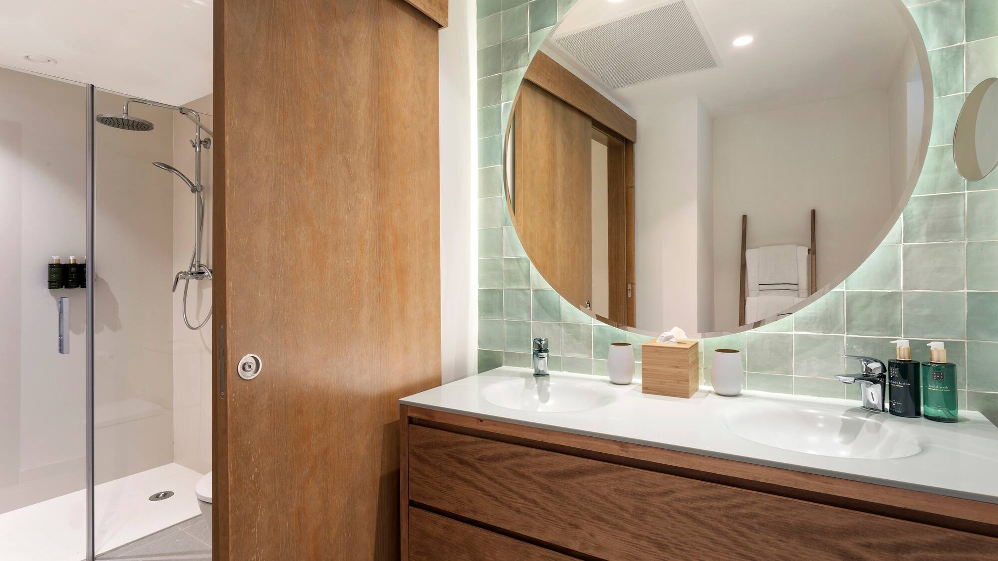 a bathroom with a round mirror