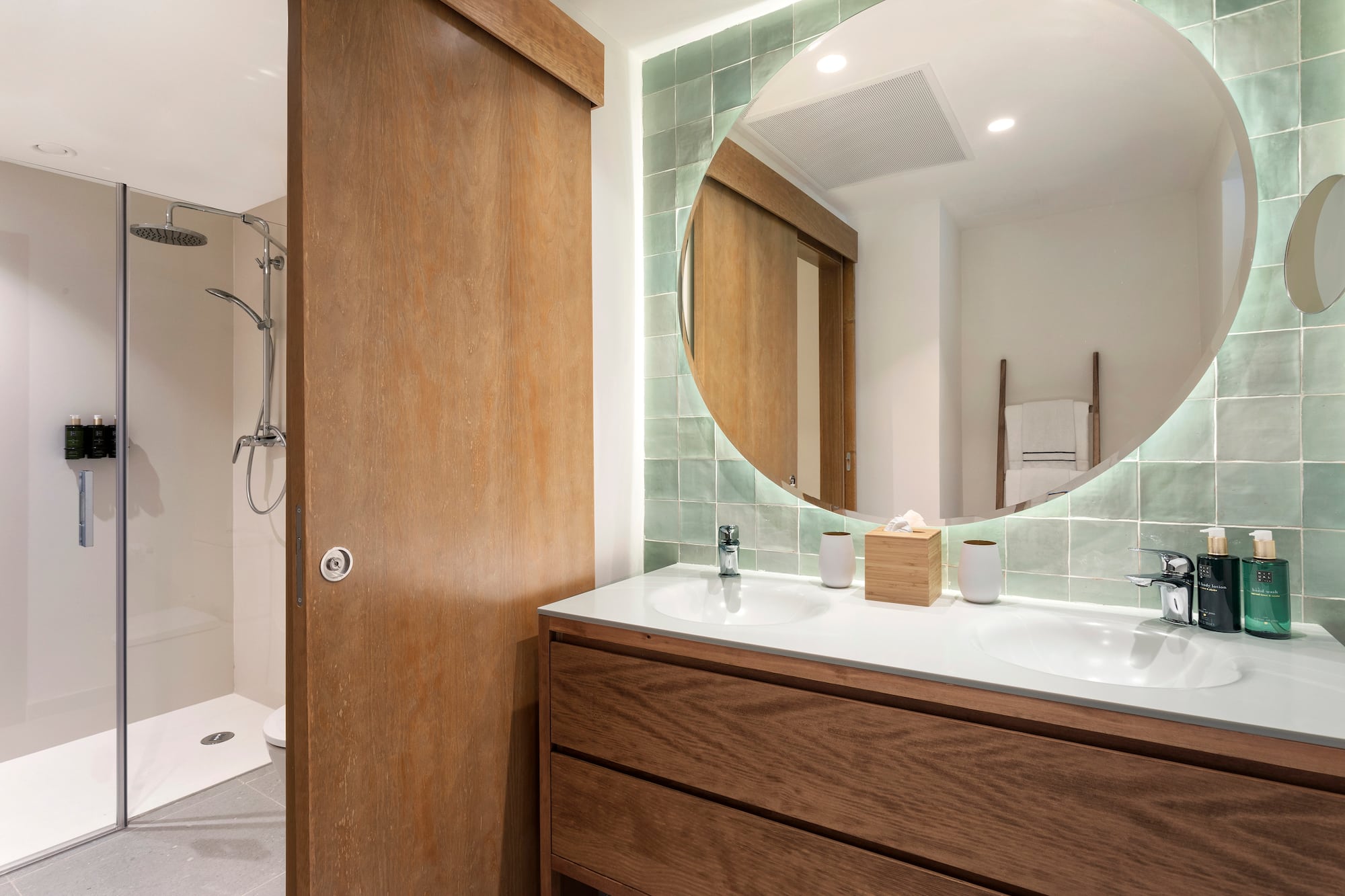 a bathroom with a round mirror