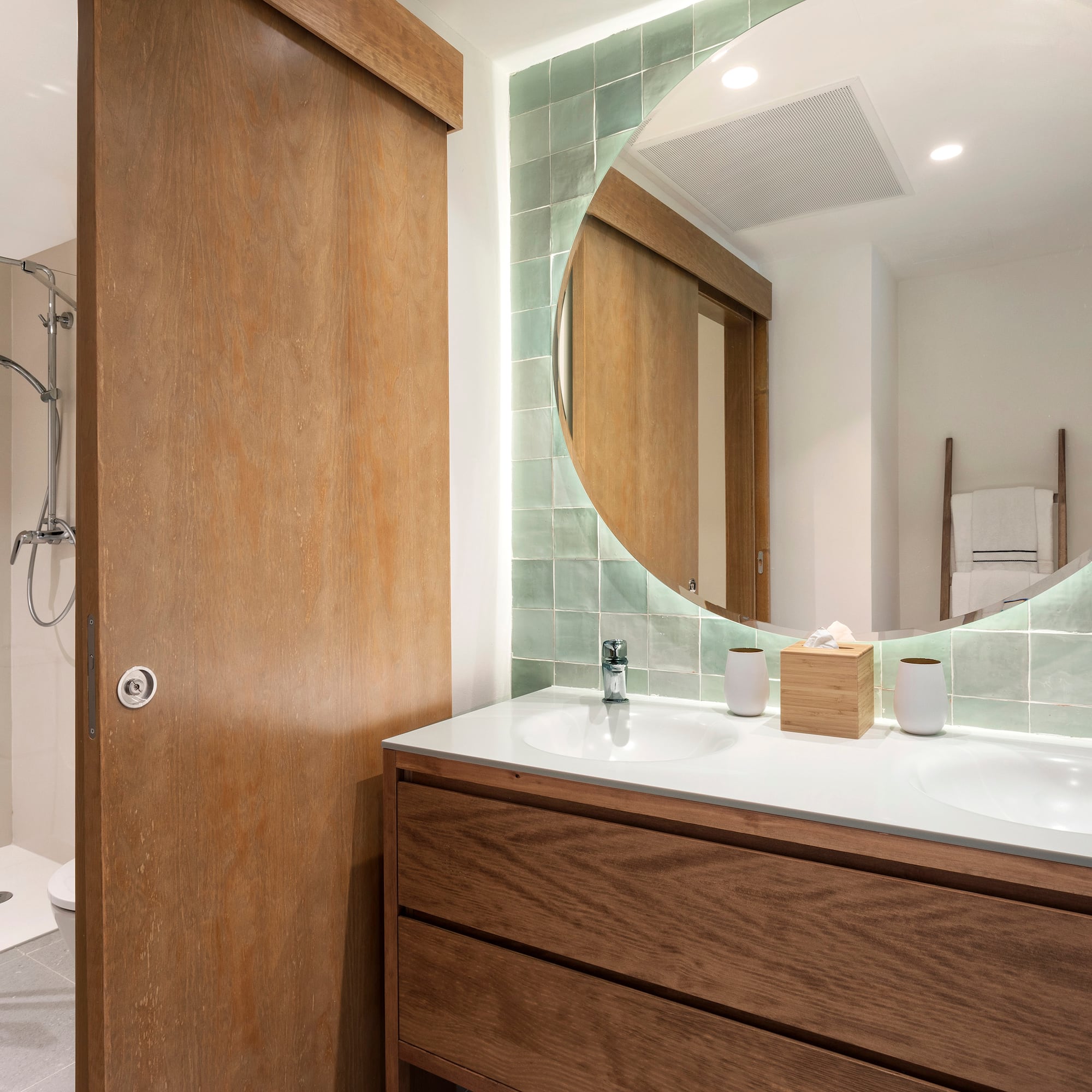 a bathroom with a round mirror