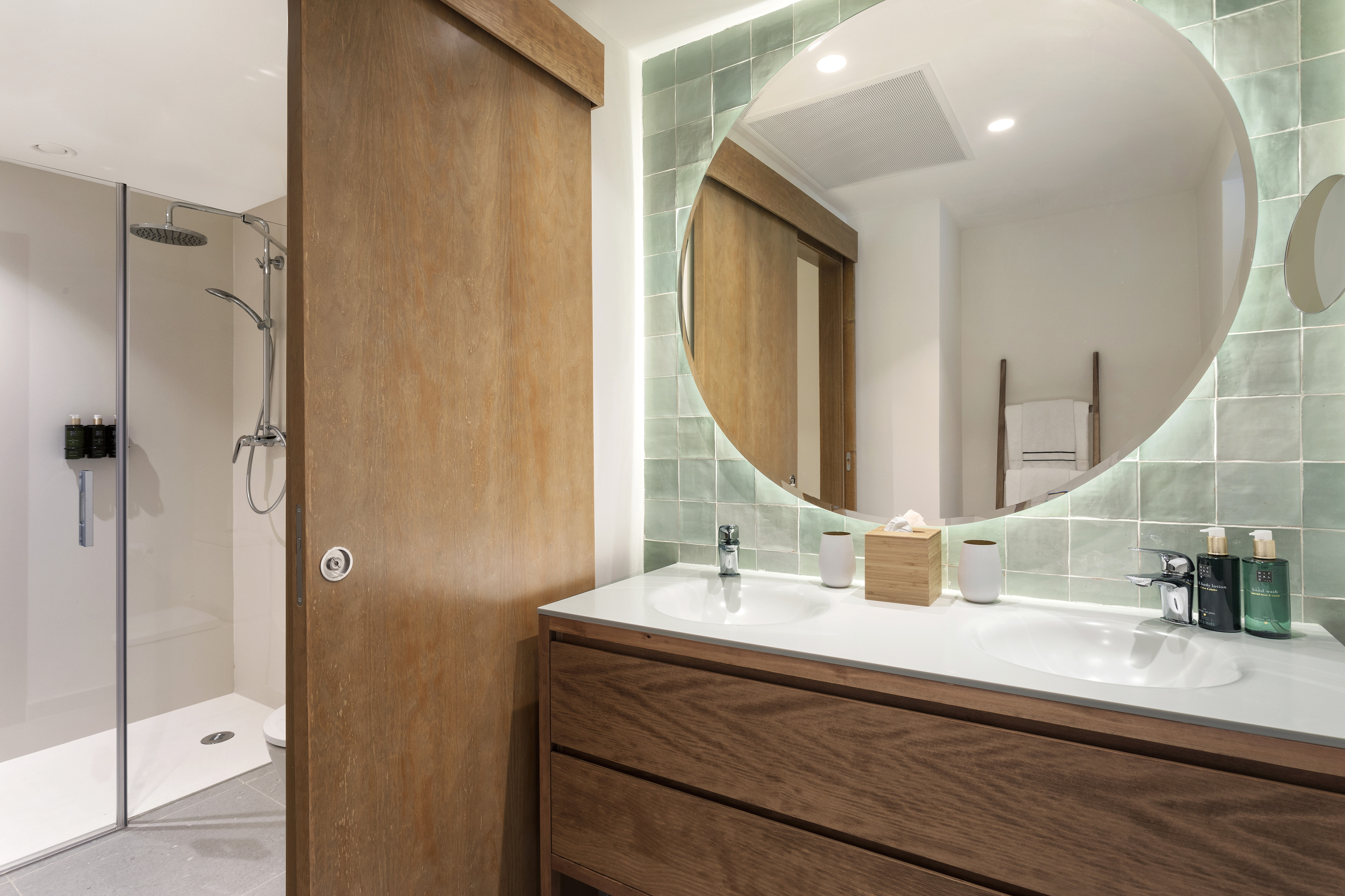 a bathroom with a round mirror