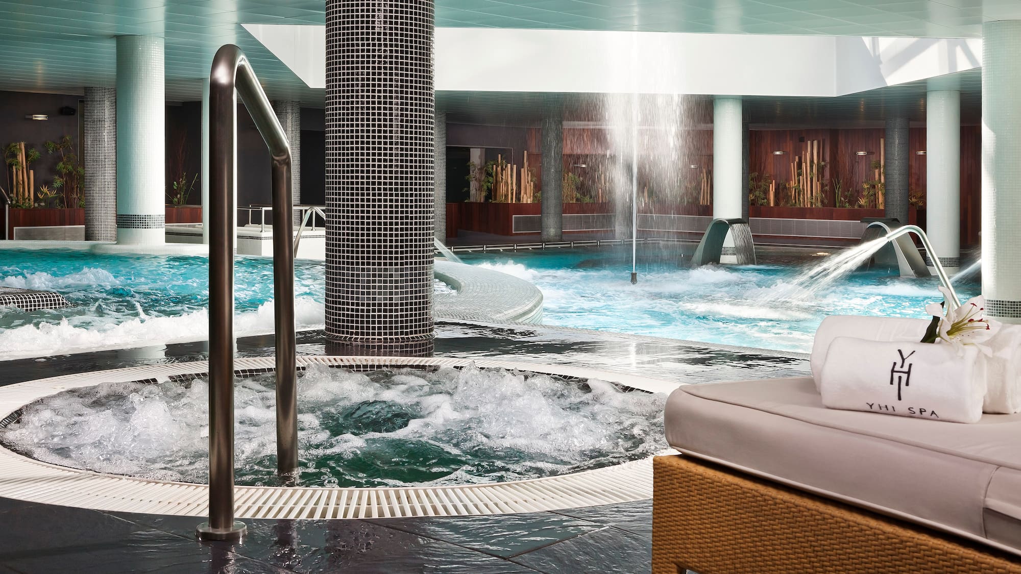 a pool with water jets and a waterfall