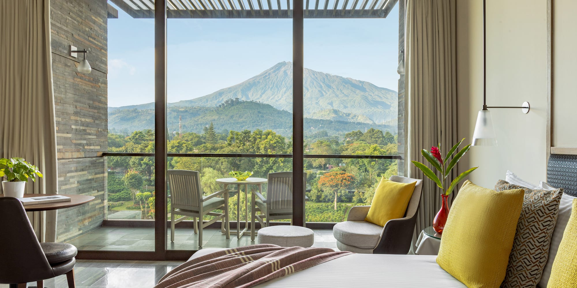 a bedroom with a view of mountains and trees