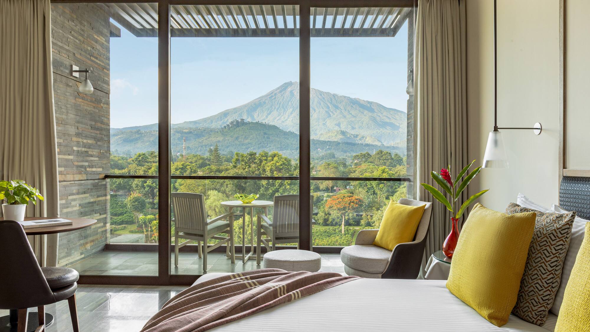 a bedroom with a view of mountains and trees