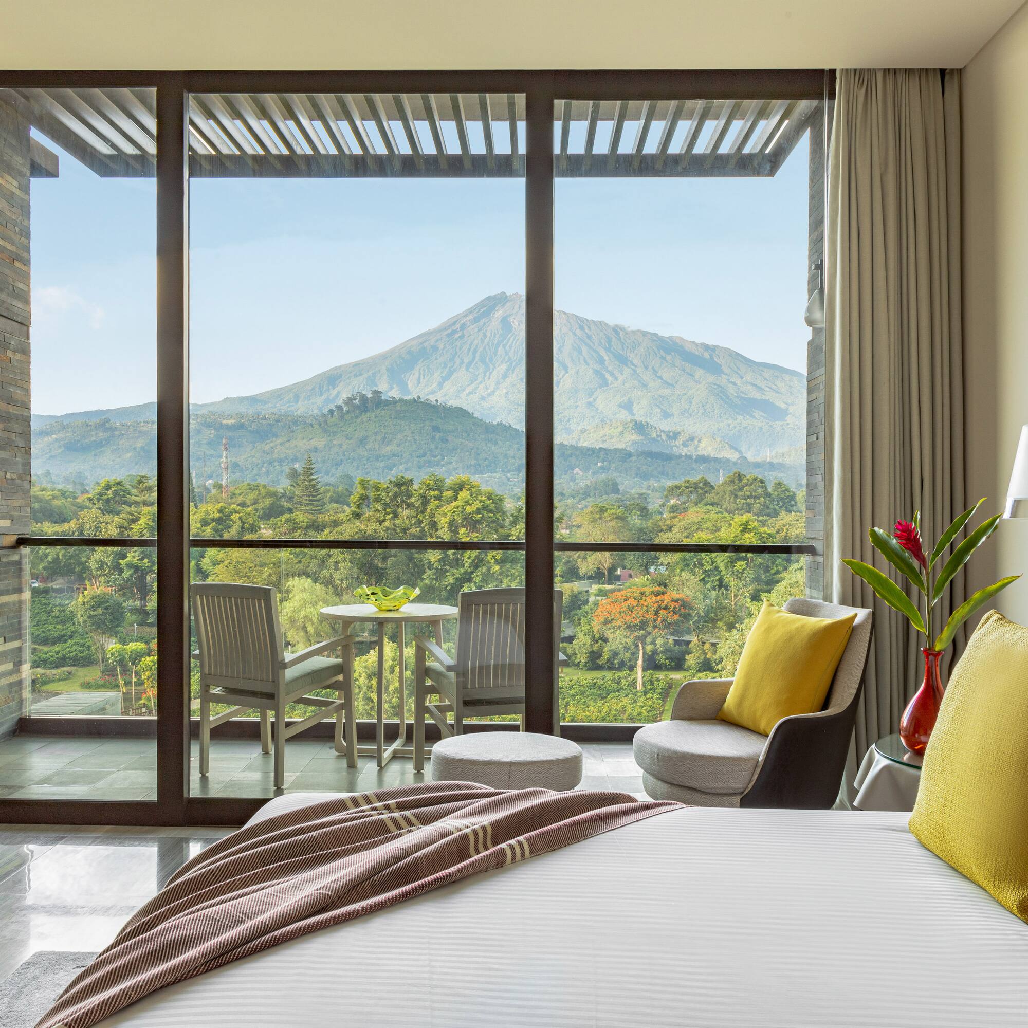 a bedroom with a view of mountains and trees