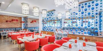 a room with red chairs and tables