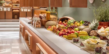 a counter with fruits and vegetables