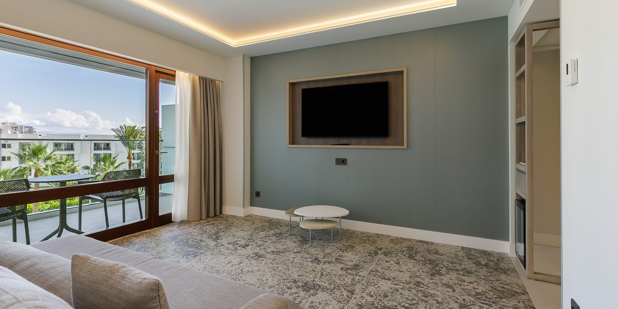 a living room with a television on the wall