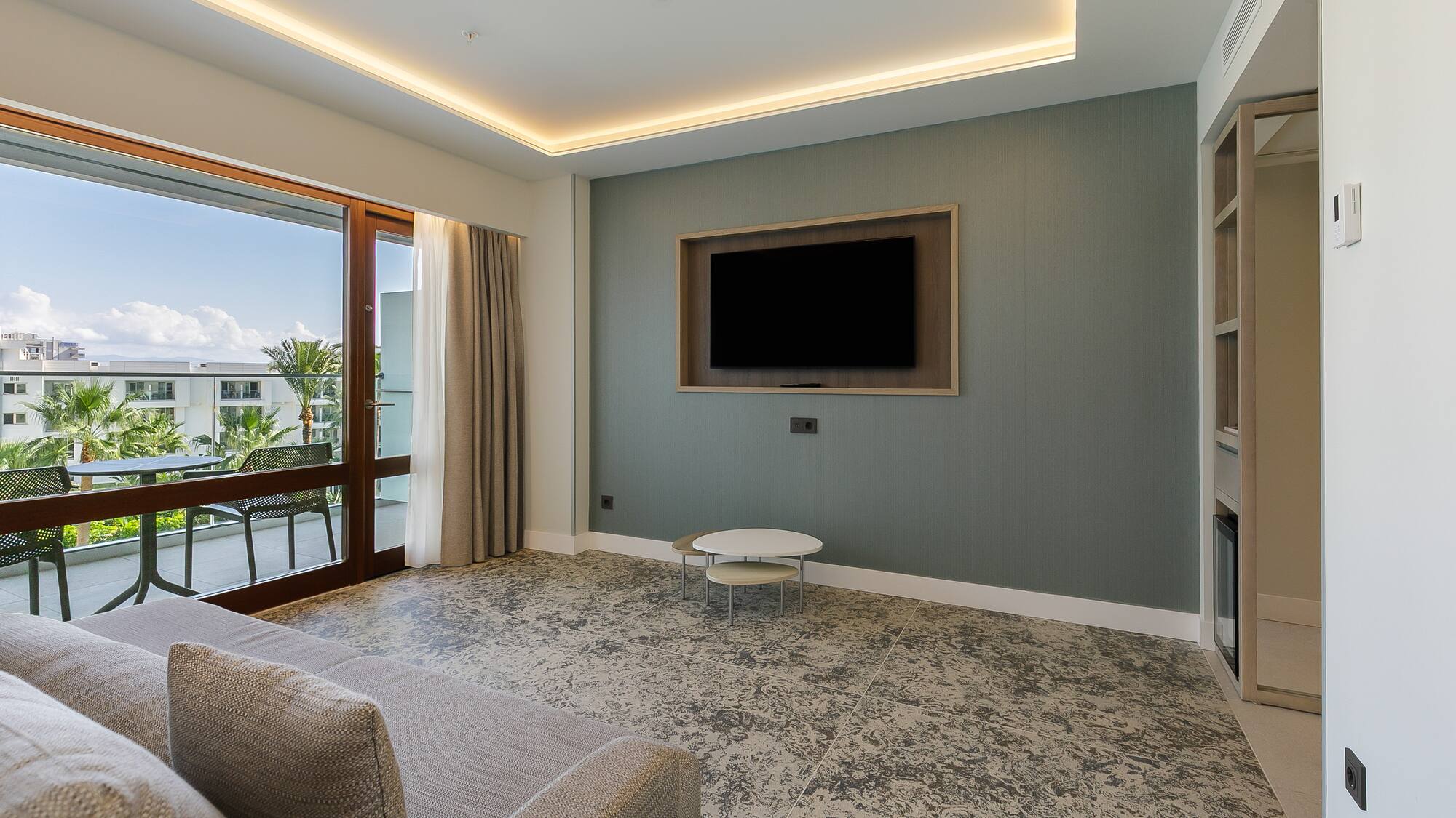 a living room with a television on the wall