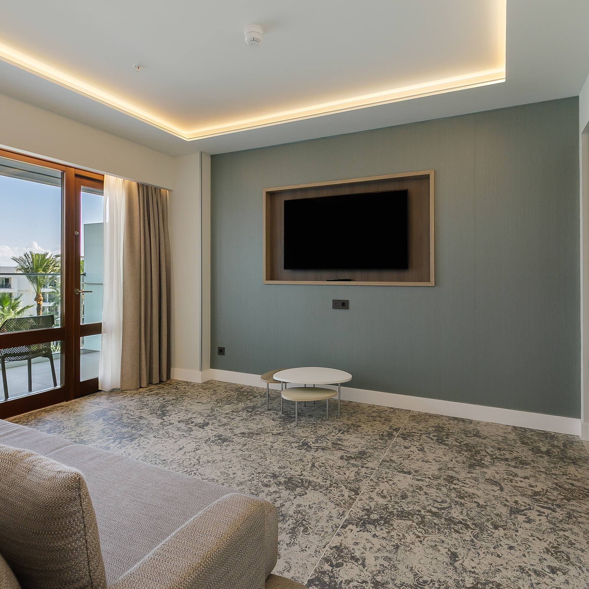 a living room with a television on the wall