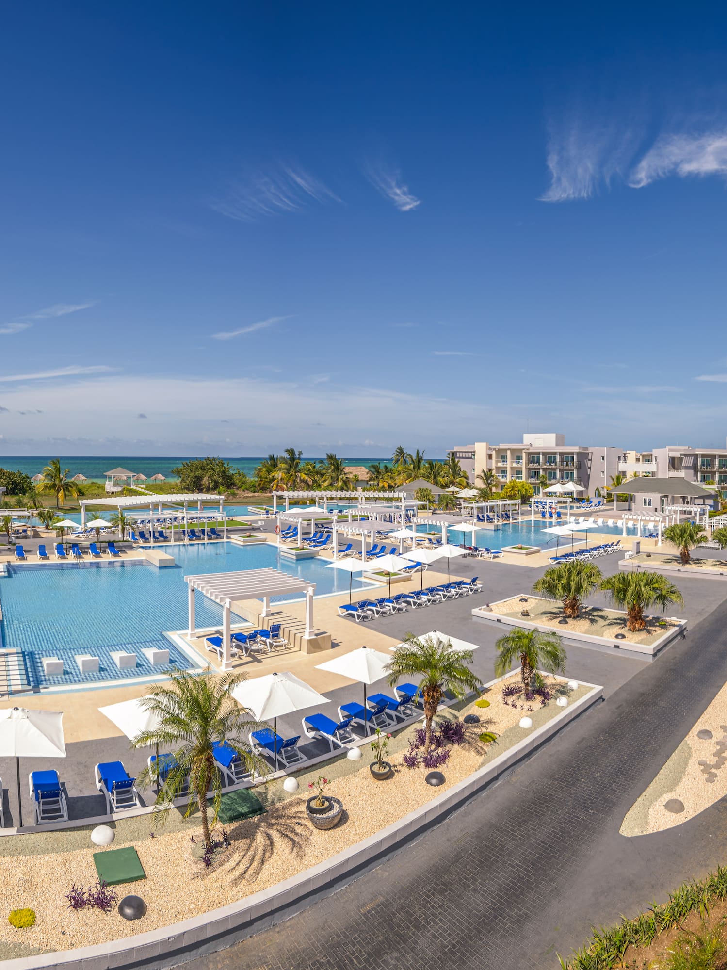 a swimming pool with umbrellas and chairs