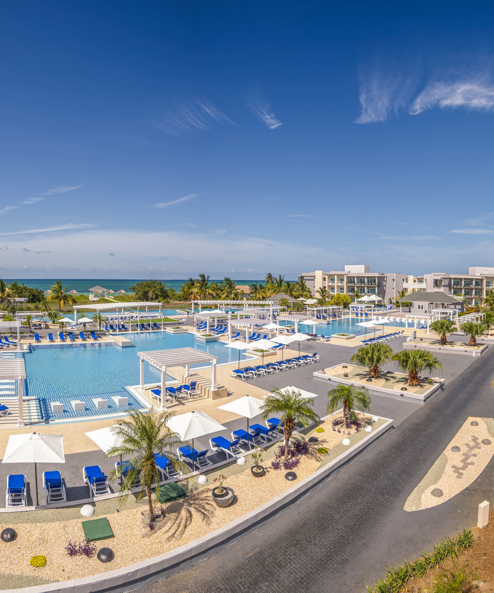 a swimming pool with umbrellas and chairs