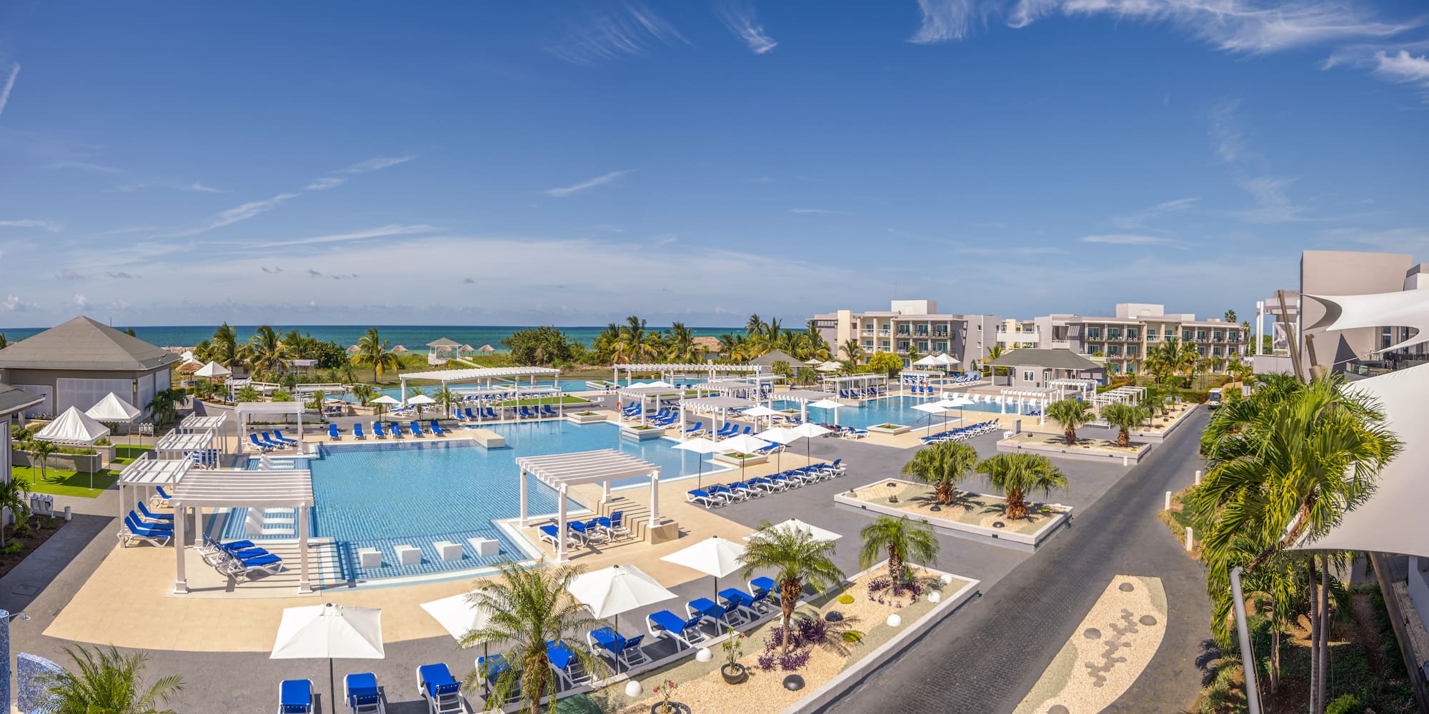 a swimming pool with umbrellas and chairs