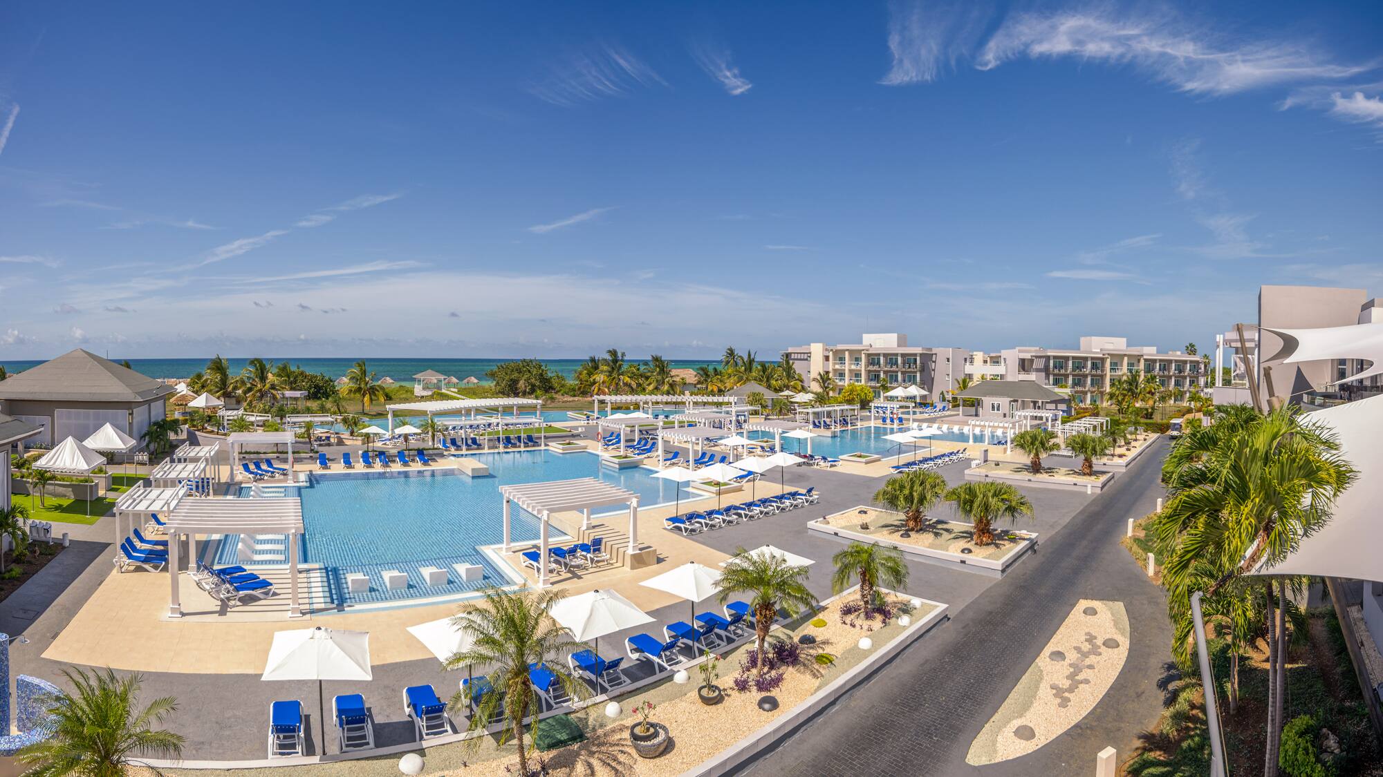 a swimming pool with umbrellas and chairs