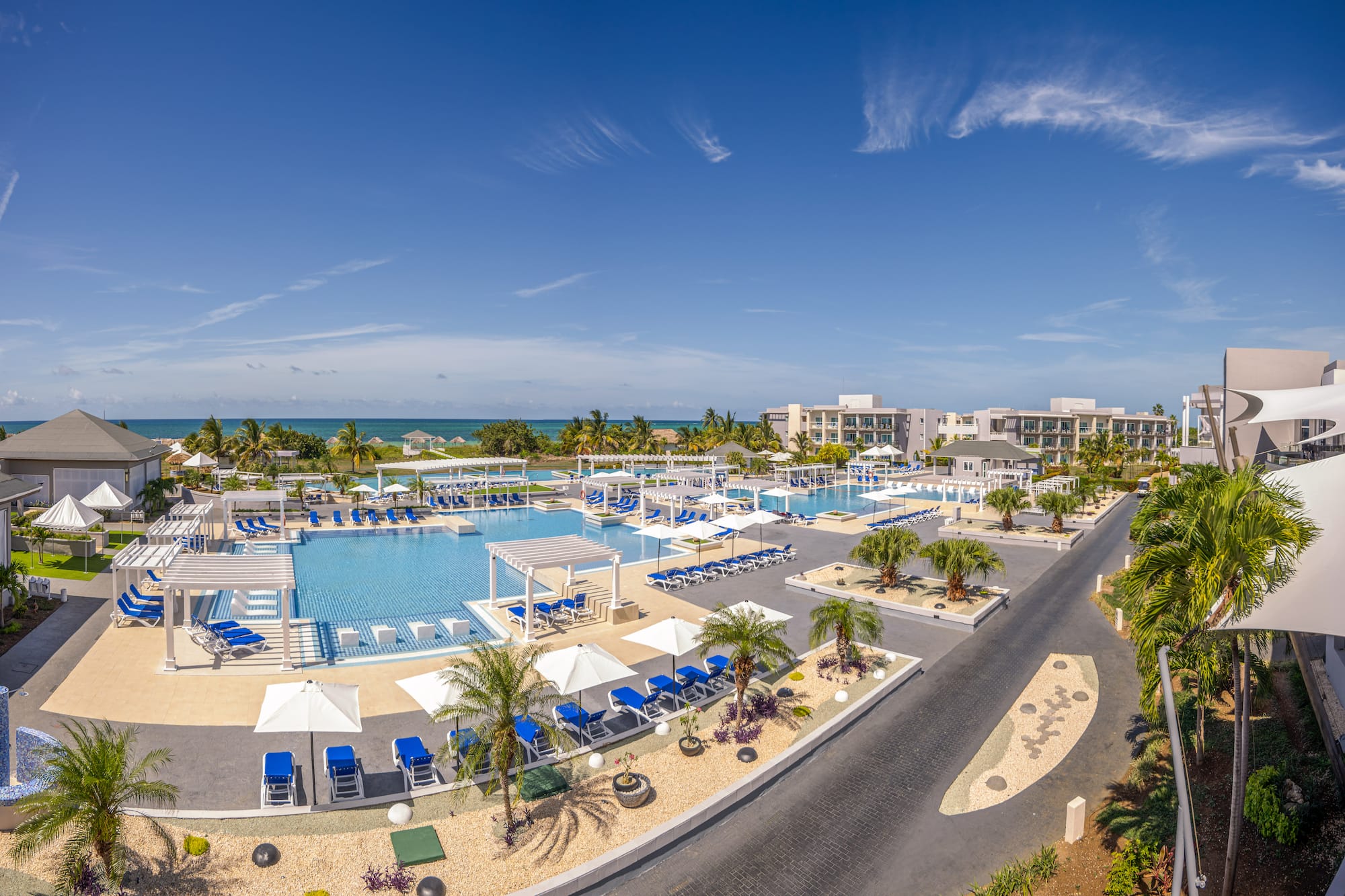 a swimming pool with umbrellas and chairs
