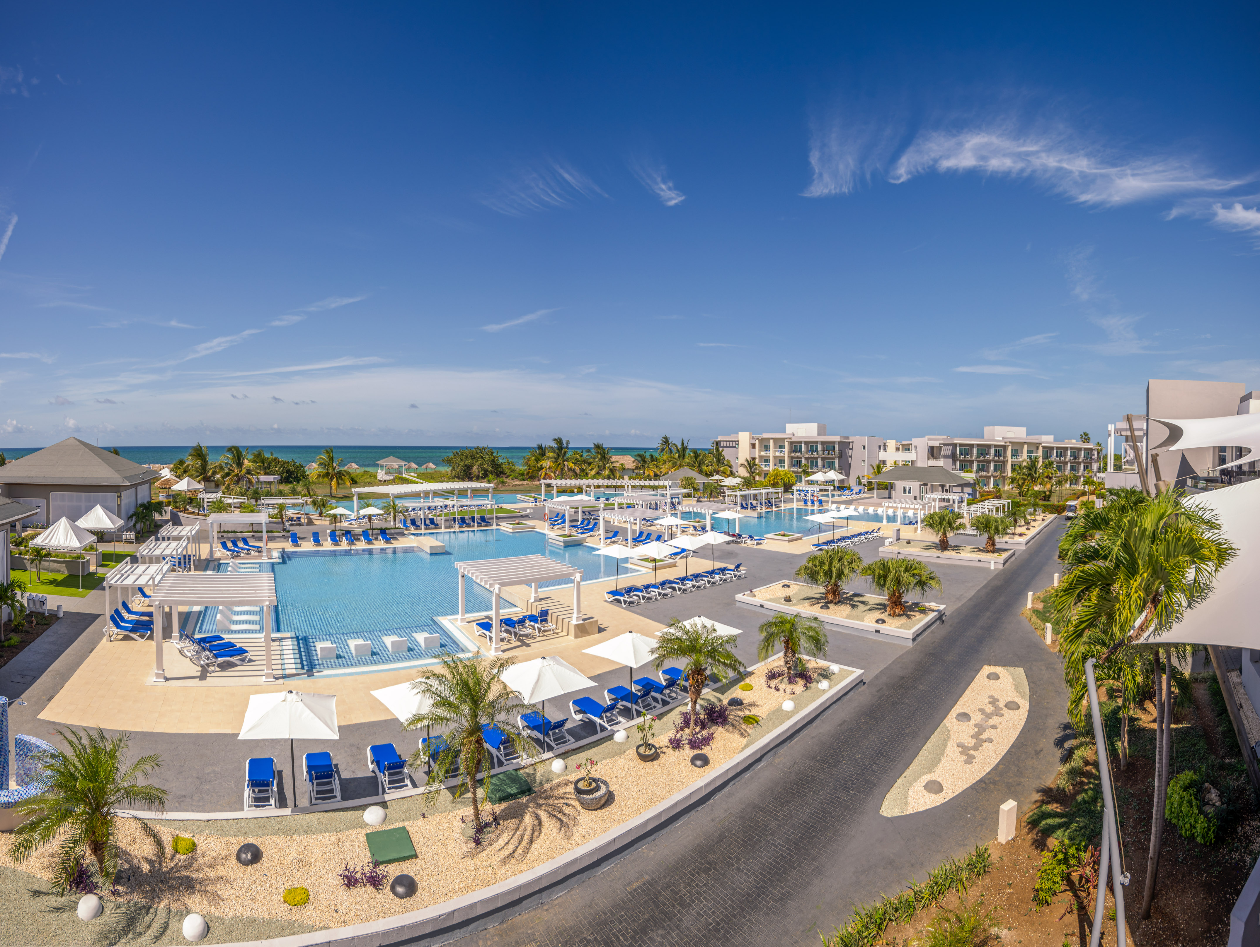 a swimming pool with umbrellas and chairs