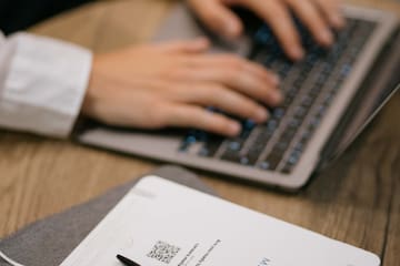 a person typing on a laptop