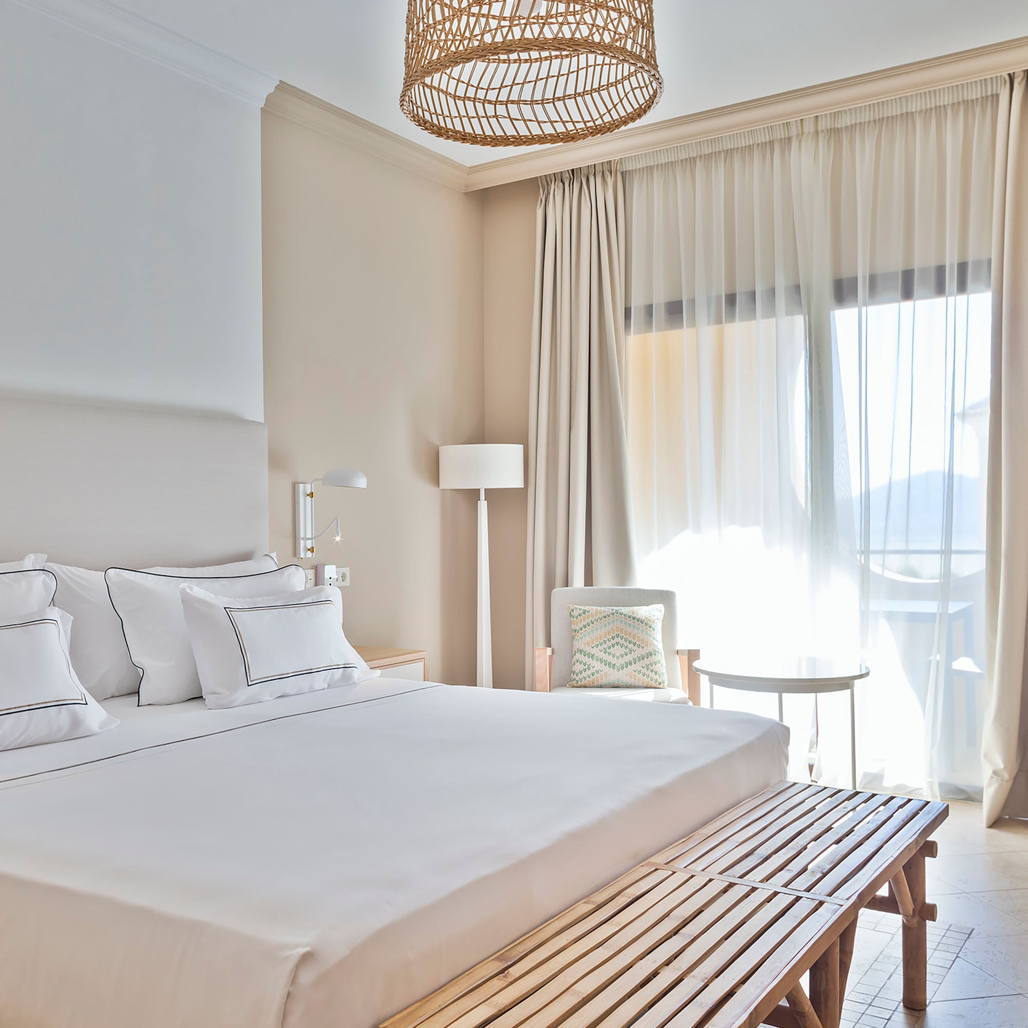 a bed with a bench and a lamp