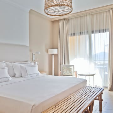 a bed with a bench and a lamp