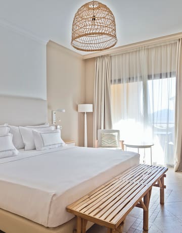 a bed with a bench and a lamp