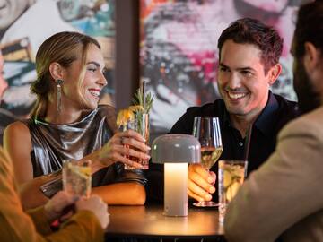 a group of people sitting at a table with drinks