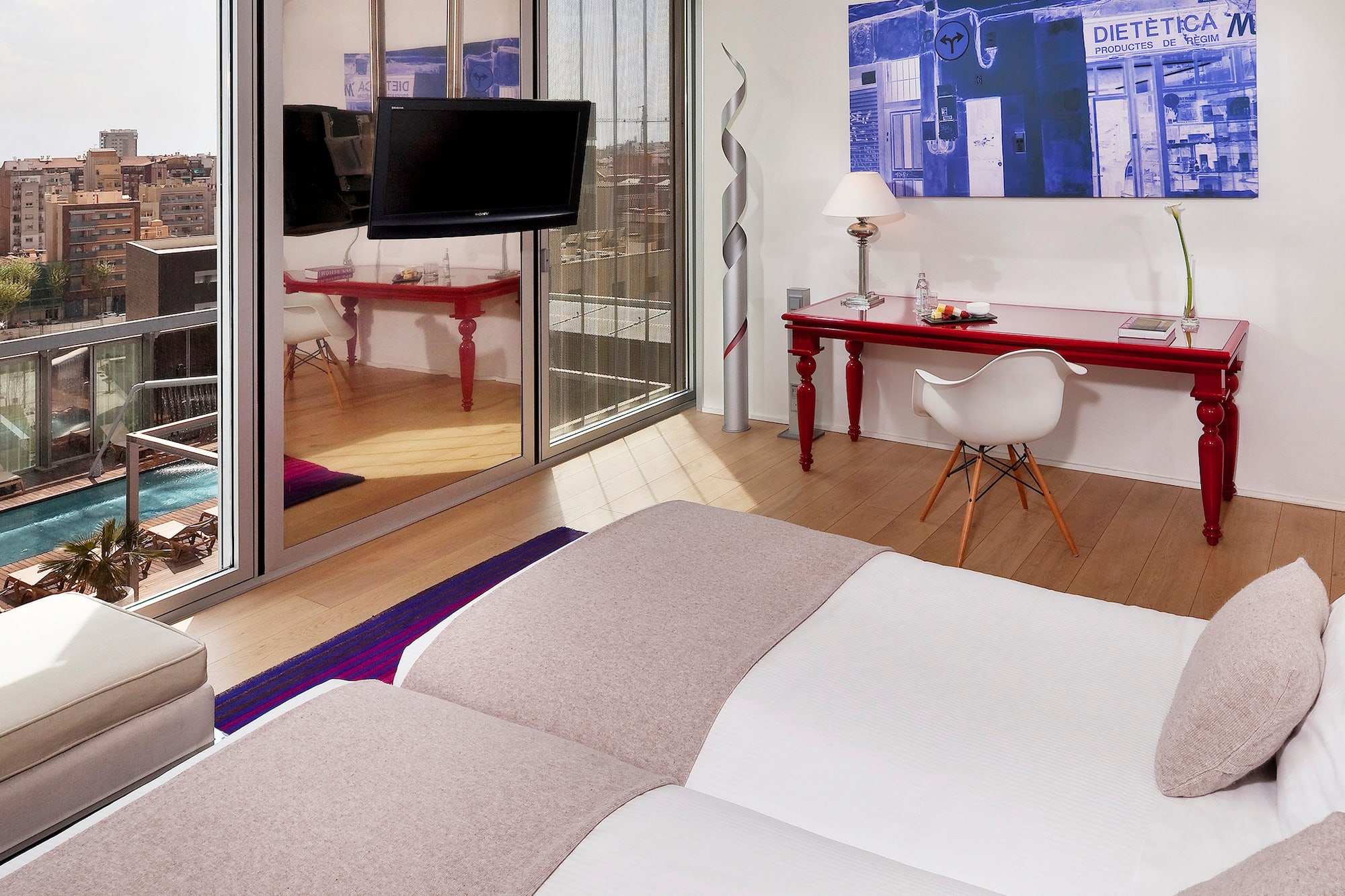 a room with a bed and a desk and a mirror