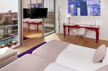 a room with a bed and a desk and a mirror