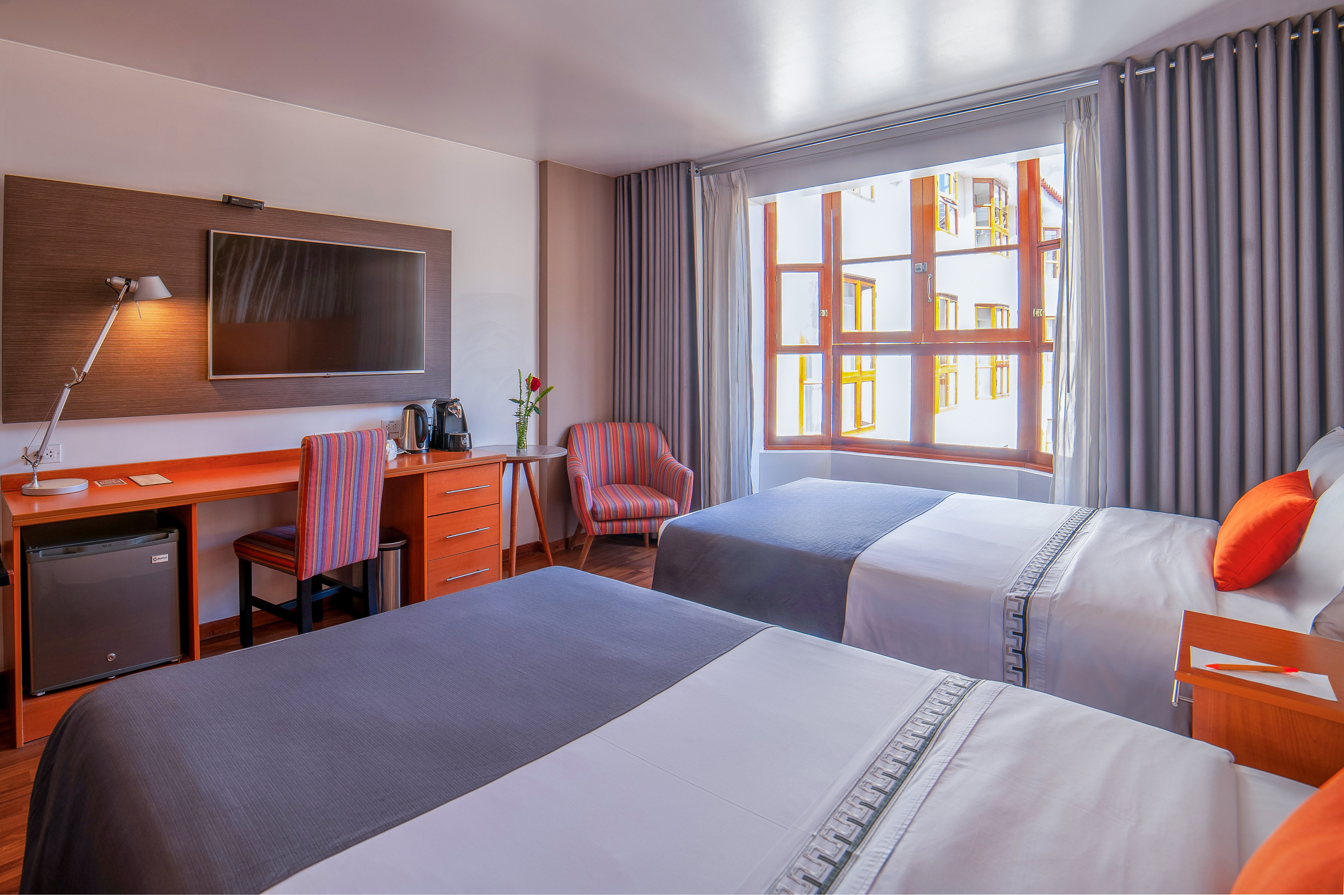 a room with two beds and a tv