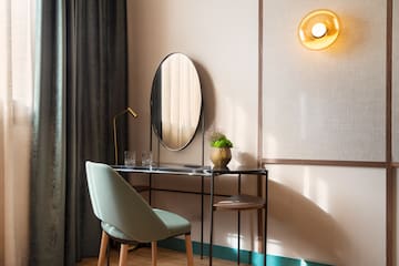 a desk with a chair and a mirror