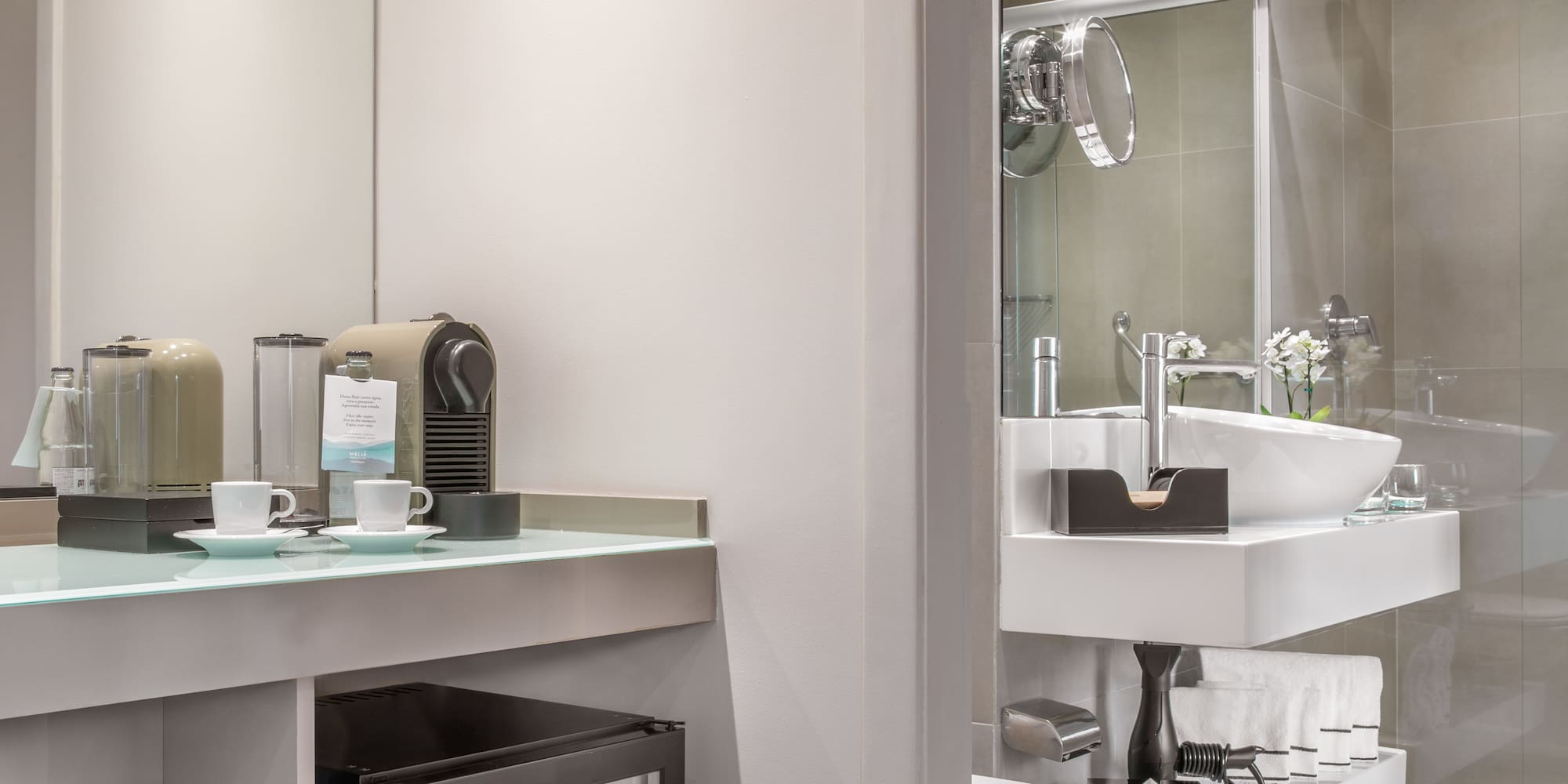 a bathroom with a sink and coffee cups