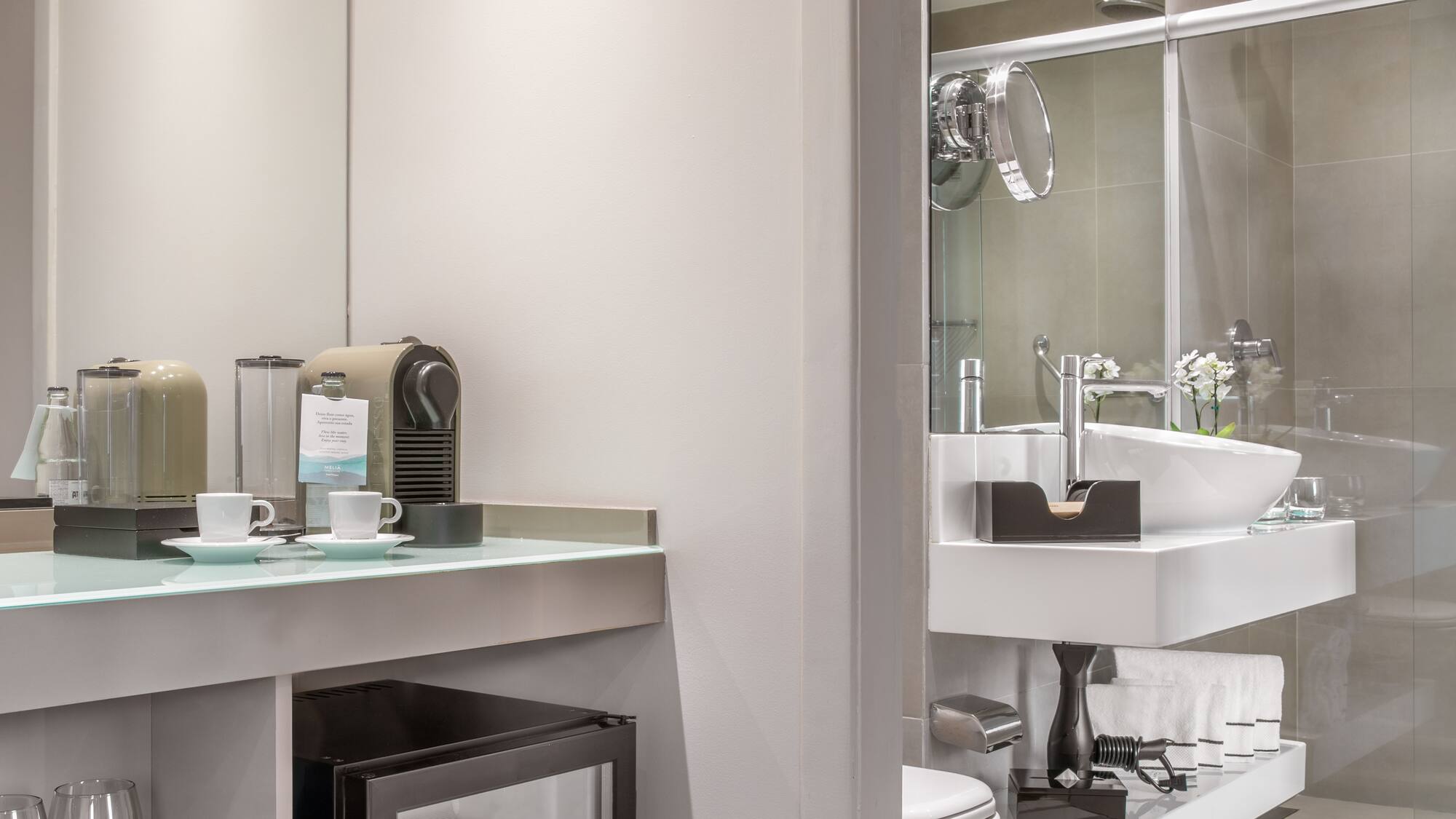 a bathroom with a sink and coffee cups