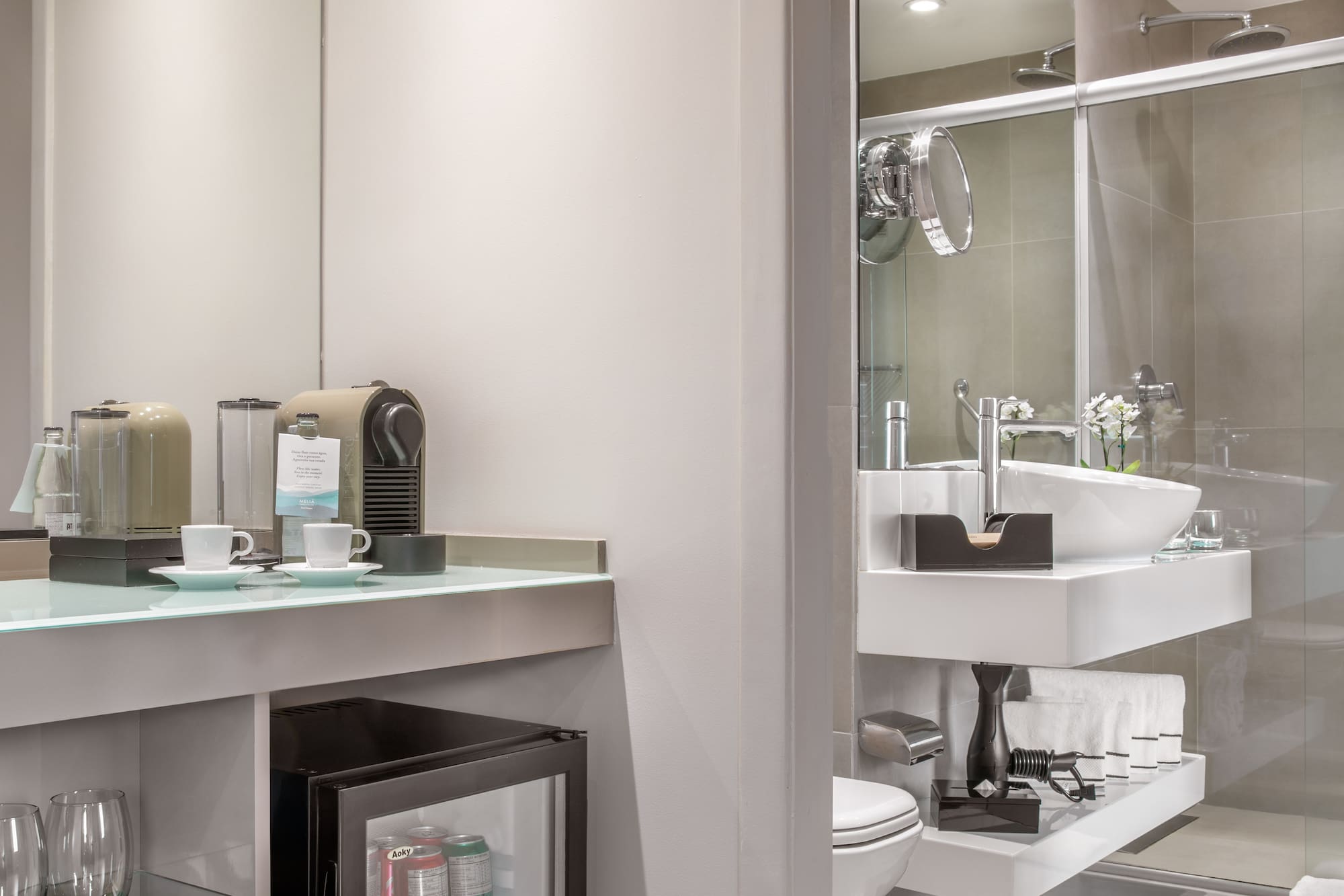 a bathroom with a sink and coffee cups