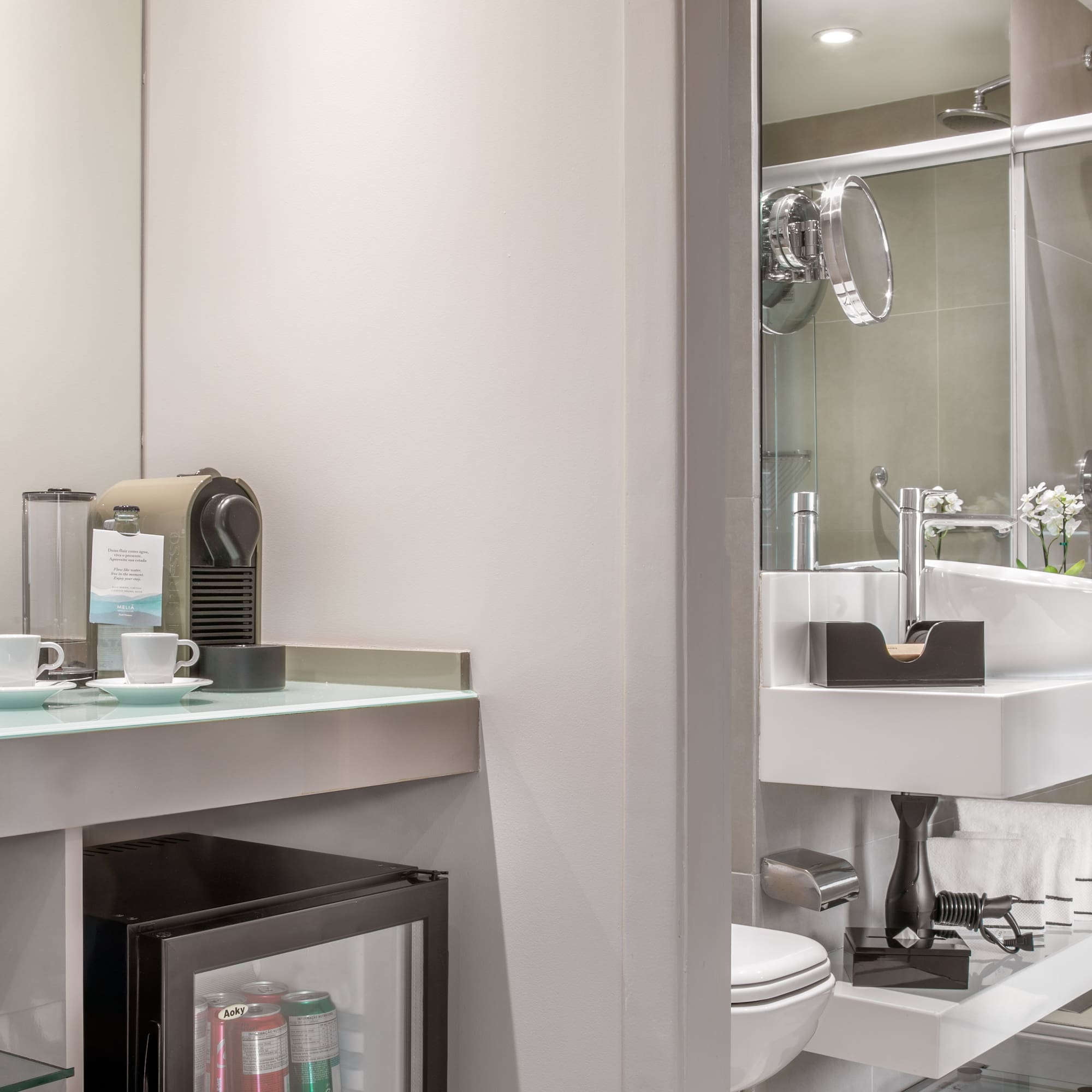 a bathroom with a sink and coffee cups