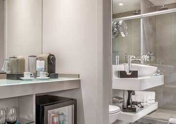 a bathroom with a sink and coffee cups