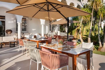a table and chairs under an umbrella