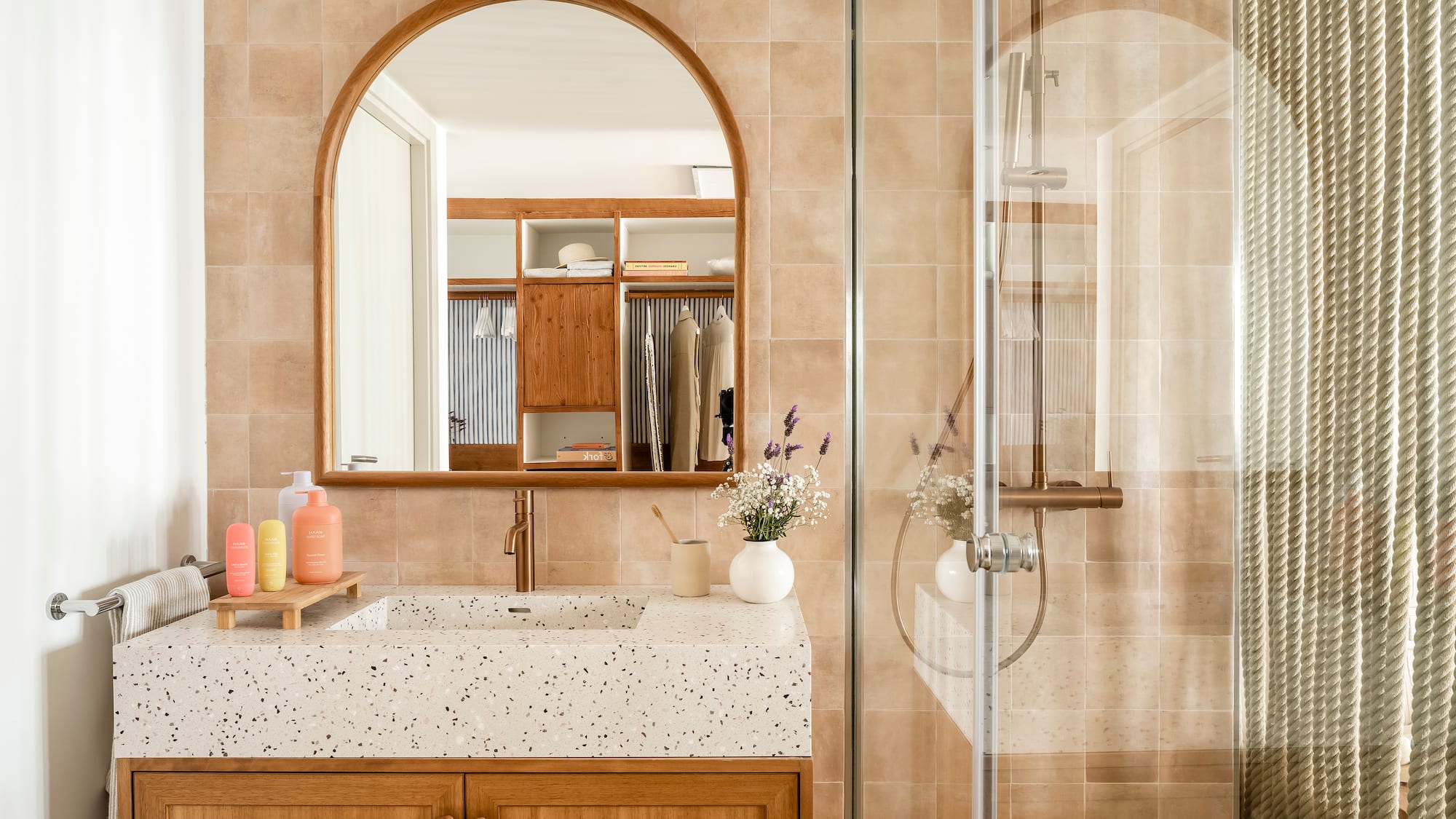 a bathroom with a glass shower door