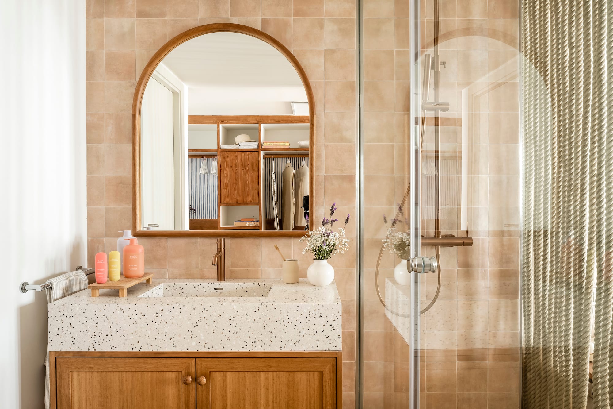 a bathroom with a glass shower door