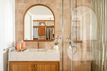 a bathroom with a glass shower door