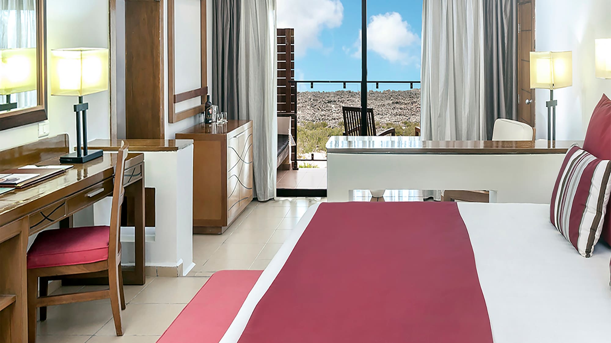 a bedroom with a large bed and a desk